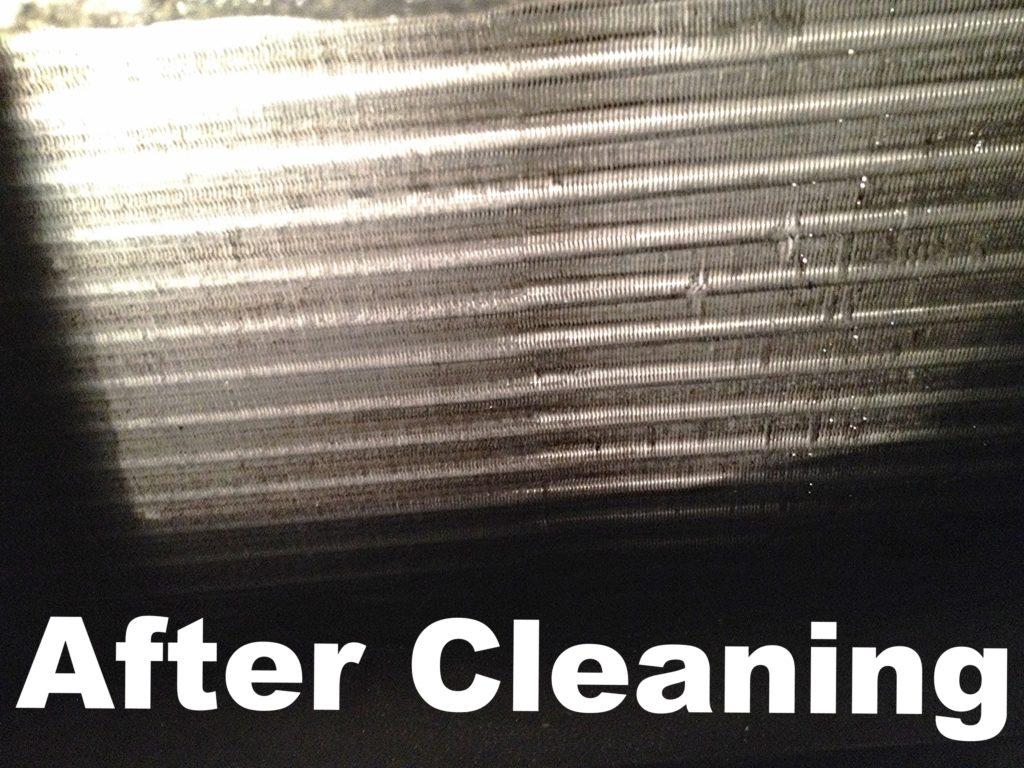 Evaporator coil after cleaning — shiny silver fins fully restored