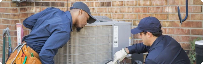 Professional installers servicing an HVAC system