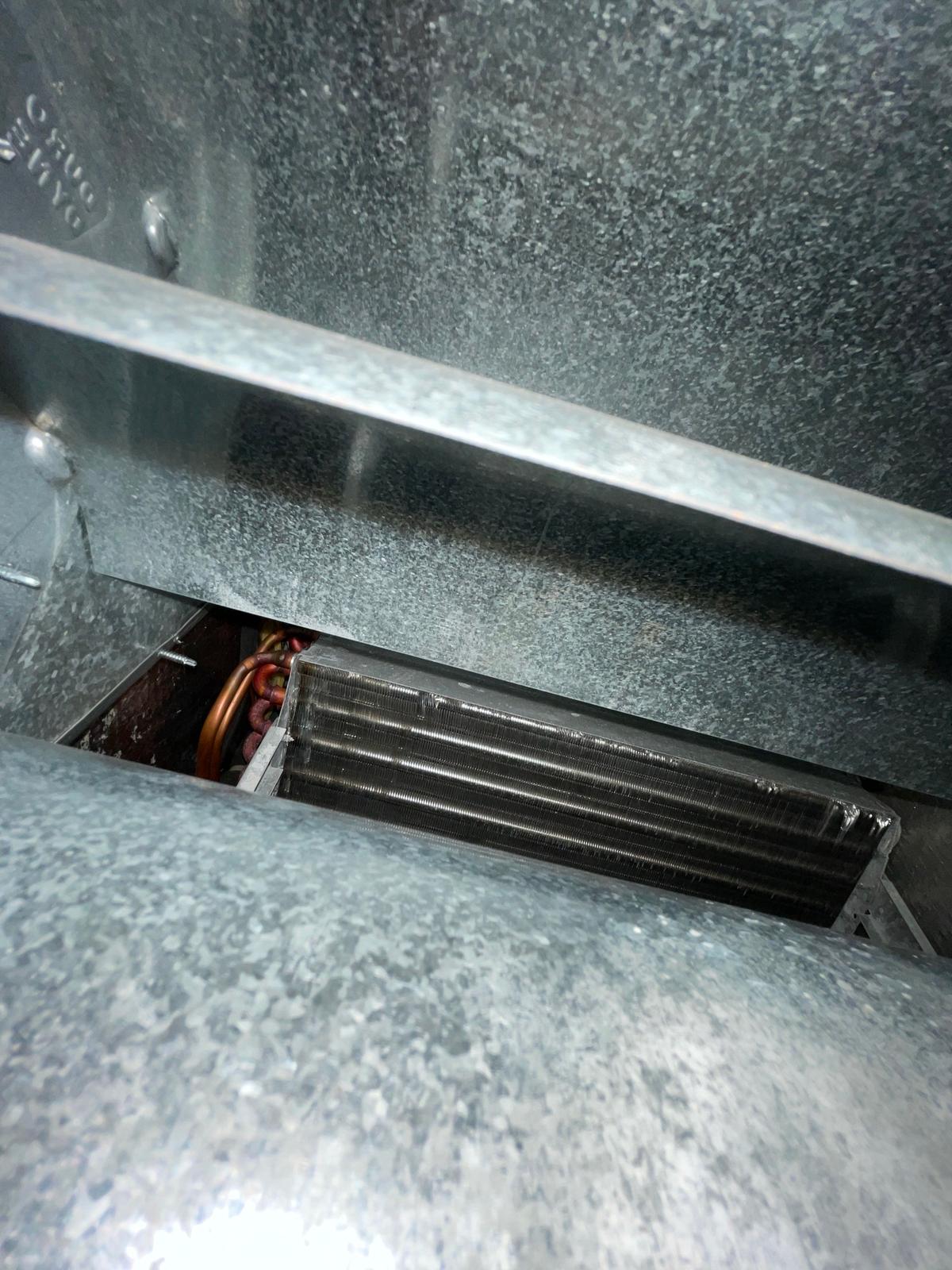 View inside supply plenum above A-coil showing UV lamp mounting location