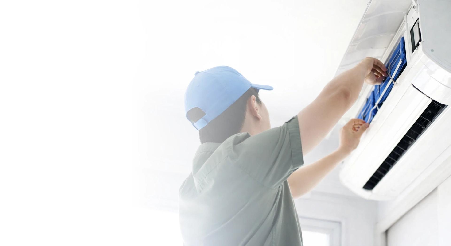 HVAC technician installing UV-C bulb in air conditioning unit