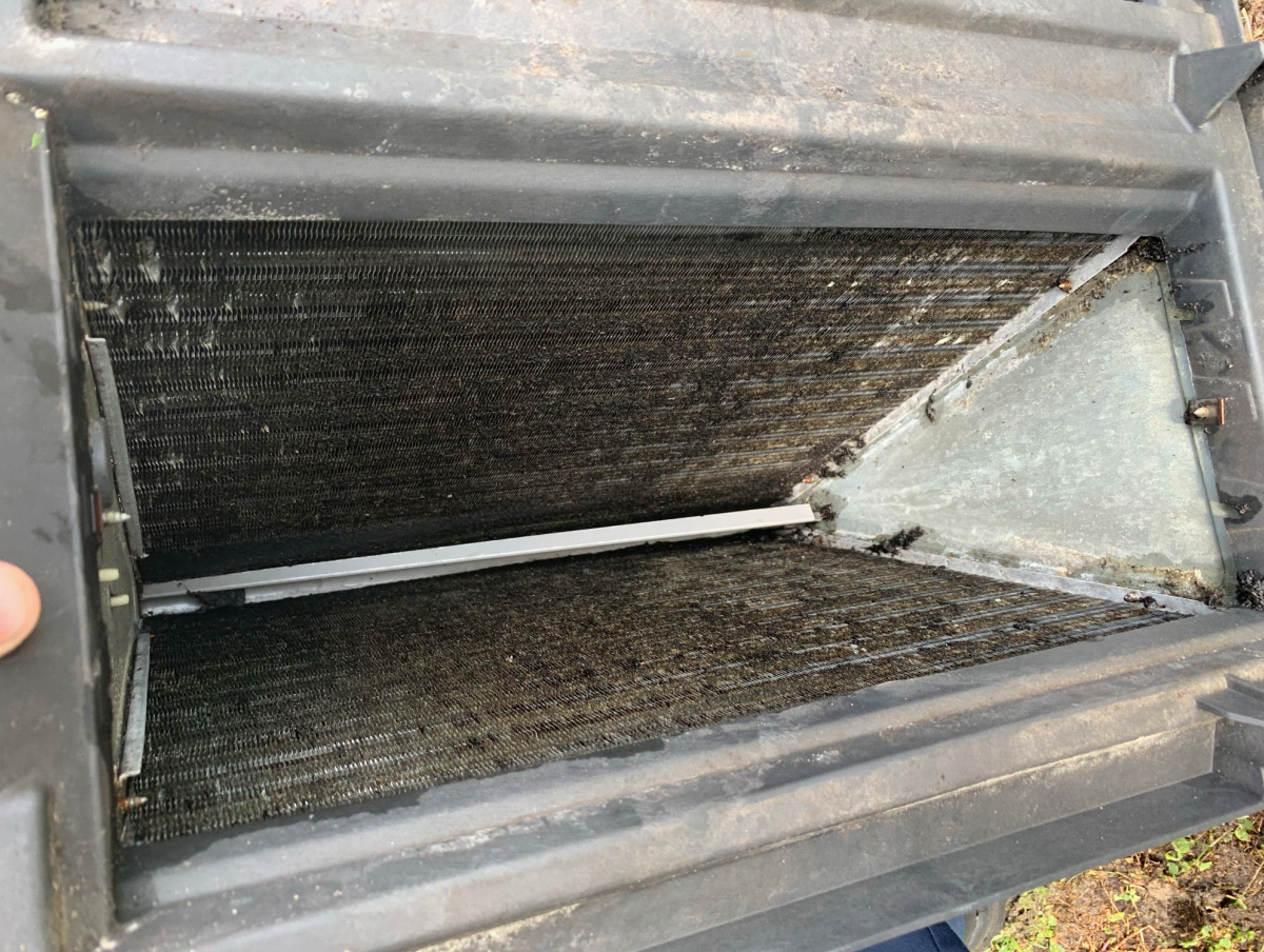 A-coil inside air handler caked with dirt and biological growth