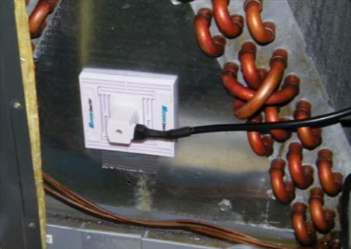 UV lamp being inserted into air handler near evaporator coil