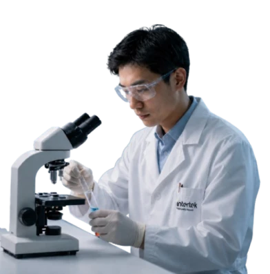 Intertek lab technician working at a microscope